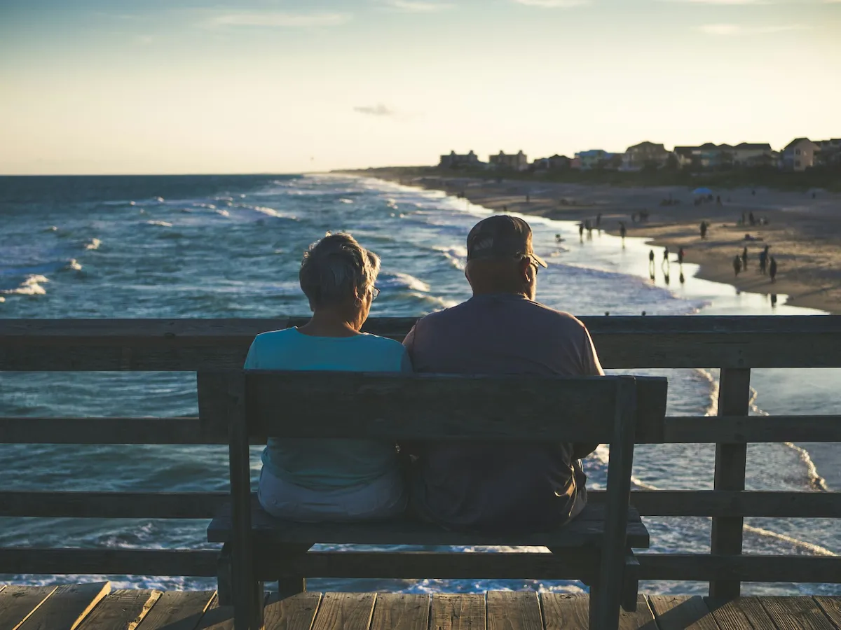 retired-couple-on-bench-over-beach.jpg