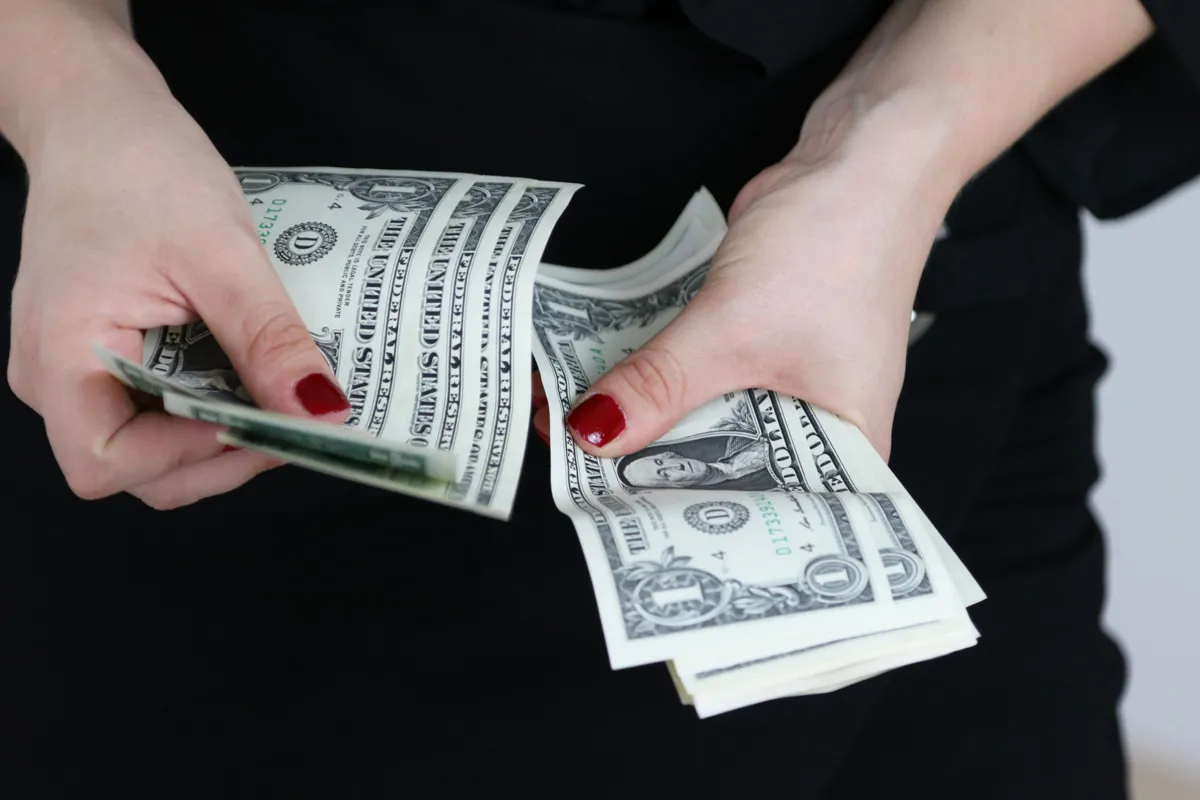 sabine-peters-woman-holding-cash-unsplash.jpg